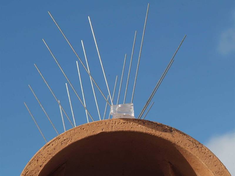 Stainless steel bird spikes on PC base installed on the brick structure for pigeons control.